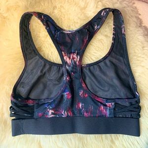 Victoria’s Secret sports bra with peep cross side-body design, size XS.